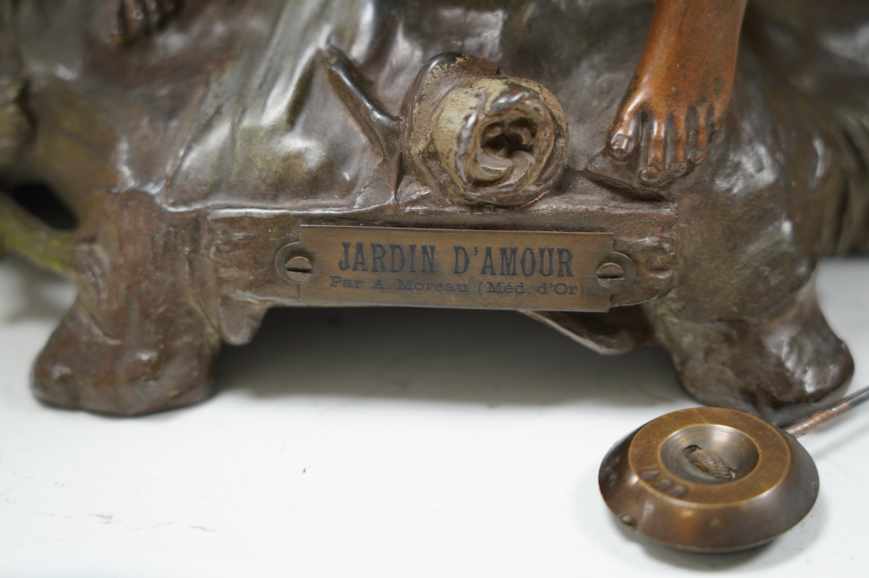 A French Art Nouveau spelter patinated figural table clock, ‘Jardin D’Amour’, with a late 19th century movement striking on a bell, height 53cm. Condition - good